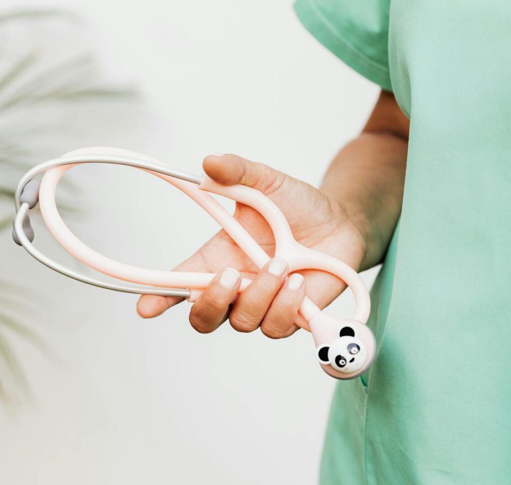 A medical professional holds a playful panda-themed stethoscope, blending fun and healthcare.